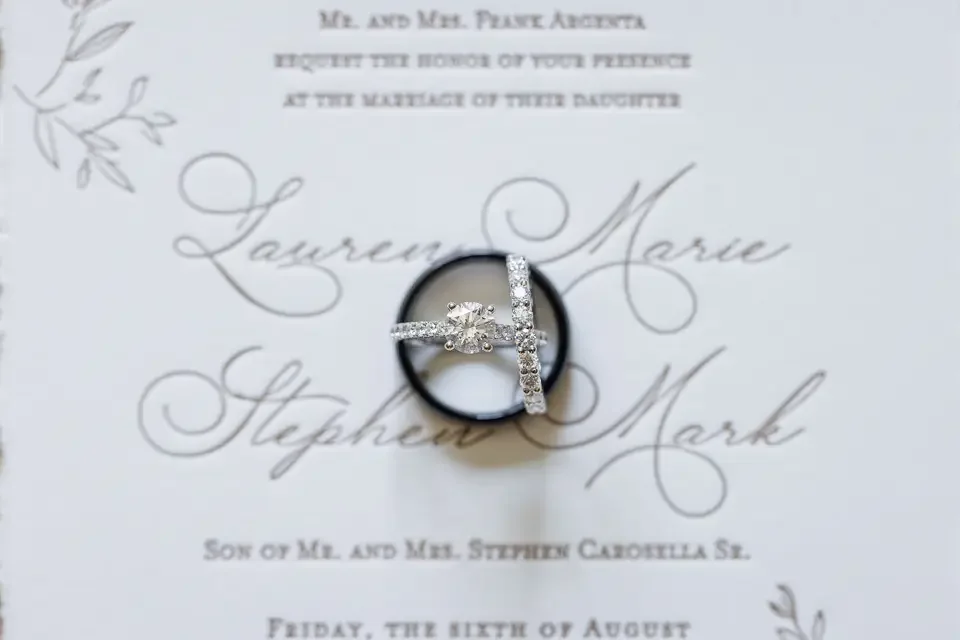 wedding-rings-on-invitation-detail.webp