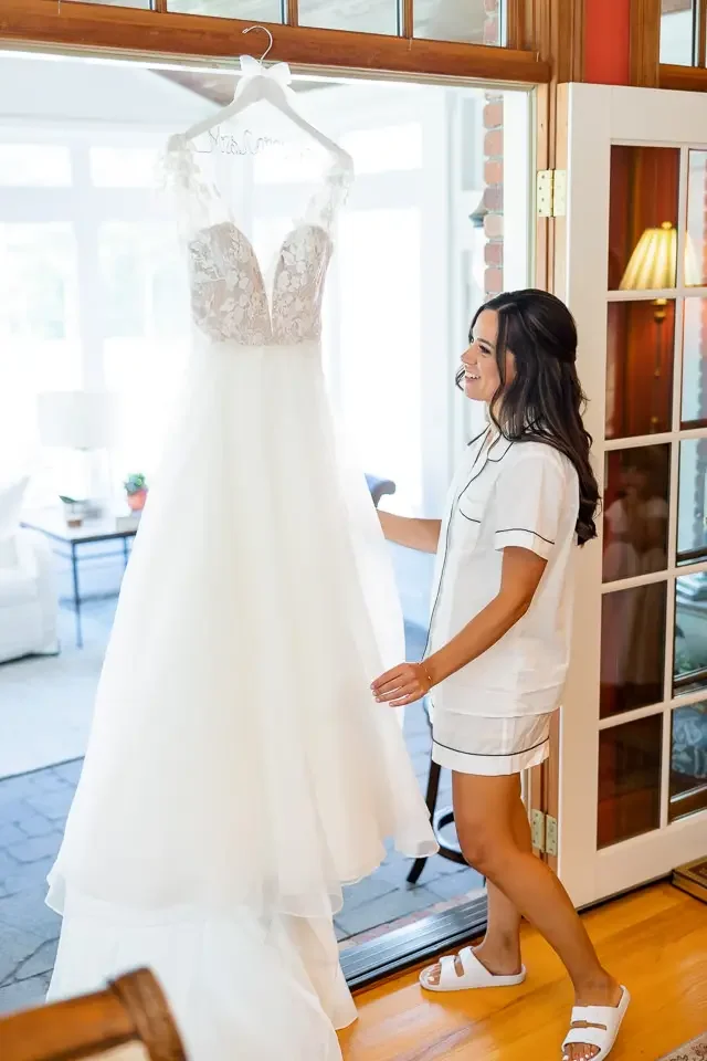 bride-looking-at-wedding-dress-getting-ready.webp
