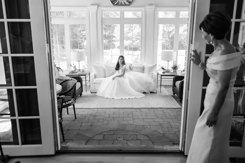 Bride reflected in a quiet moment before the ceremony, photographed in a calm, candid style