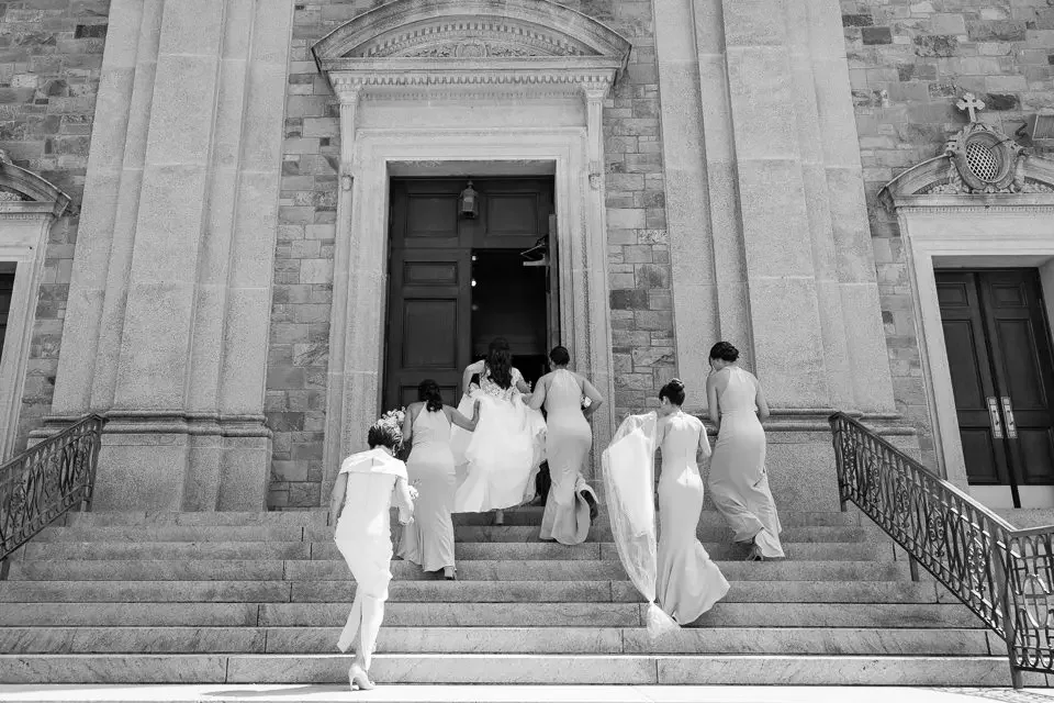 bridal-party-entering-church-ceremony-black-and-white.webp