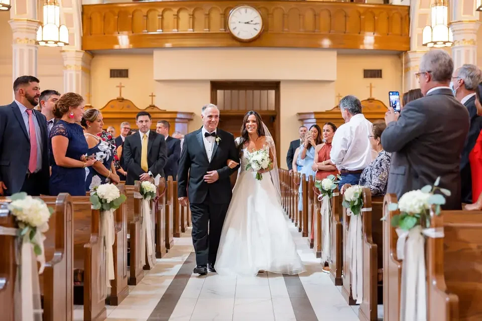 bride-walking-down-church-aisle-with-father.webp