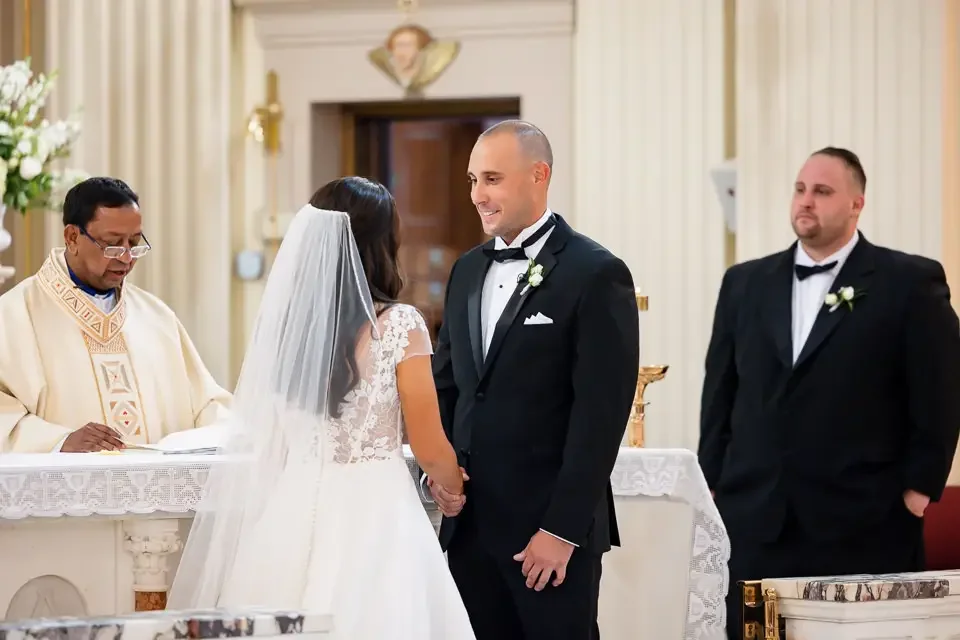 bride-and-groom-holding-hands-at-church-altar.webp