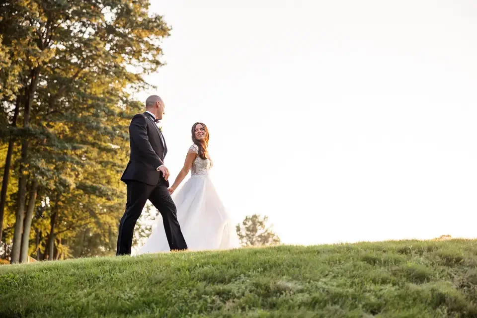 bride-and-groom-walking-during-wedding-portraits.webp