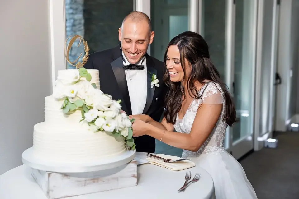 bride-and-groom-cutting-wedding-cake.webp