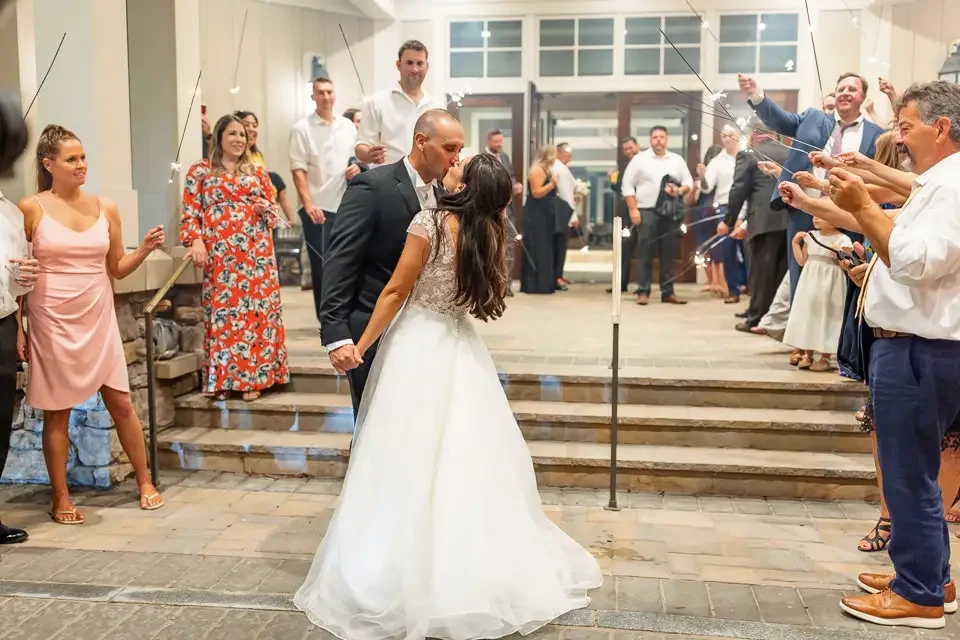 sparkler-exit-wedding-kiss-at-night.webp