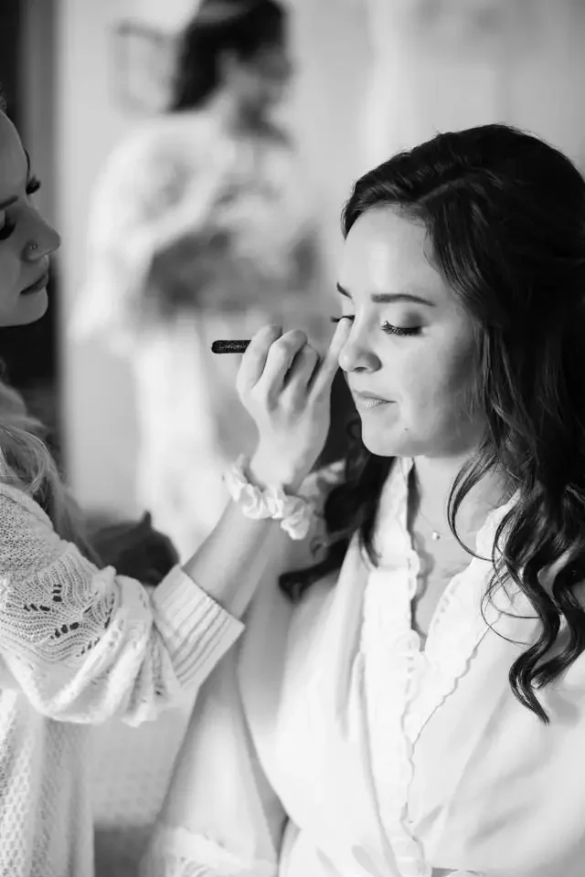 bride-getting-ready-makeup-black-and-white.webp