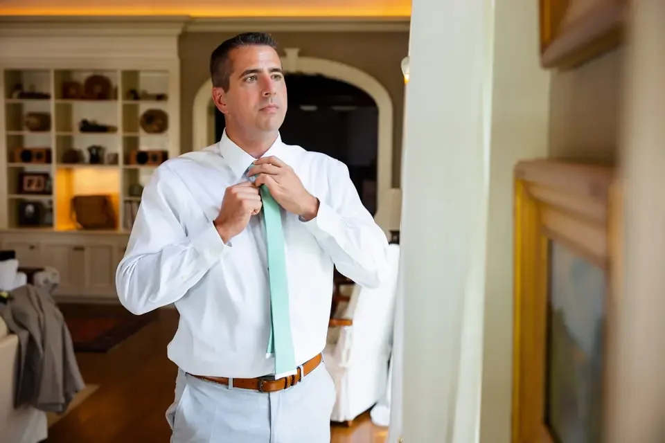 groom-adjusting-tie-getting-ready.webp