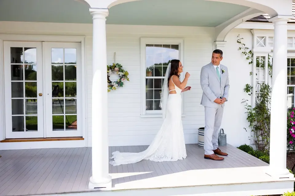 wedding-first-look-on-porch-smith-farm-gardens.webp