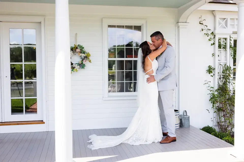 romantic-first-look-kiss-on-porch.webp