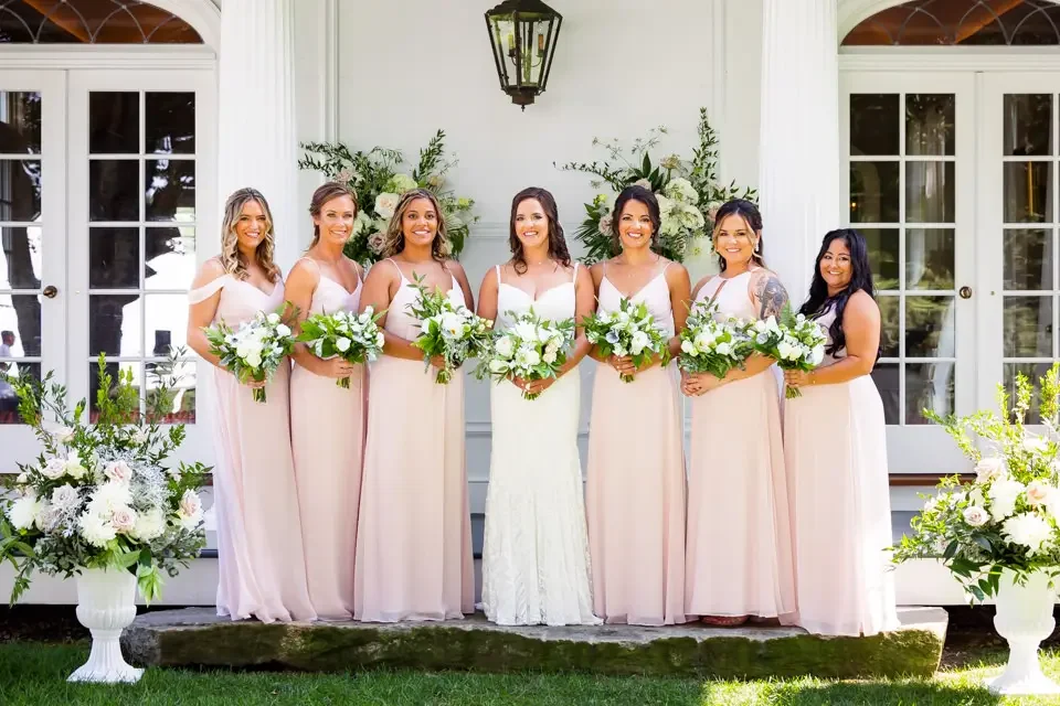 bridesmaids-and-bride-porch-portrait-smith-farm-gardens.webp