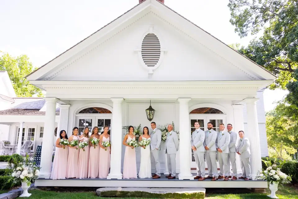 full-wedding-party-porch-portrait-smith-farm-gardens.webp