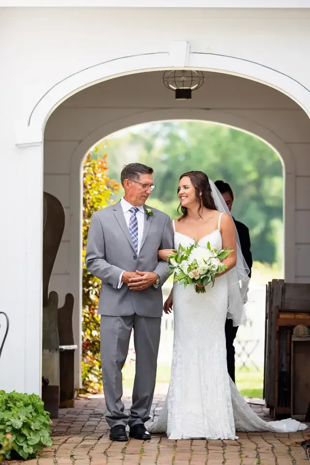 bride-entering-ceremony-with-father-smith-farm-gardens.webp