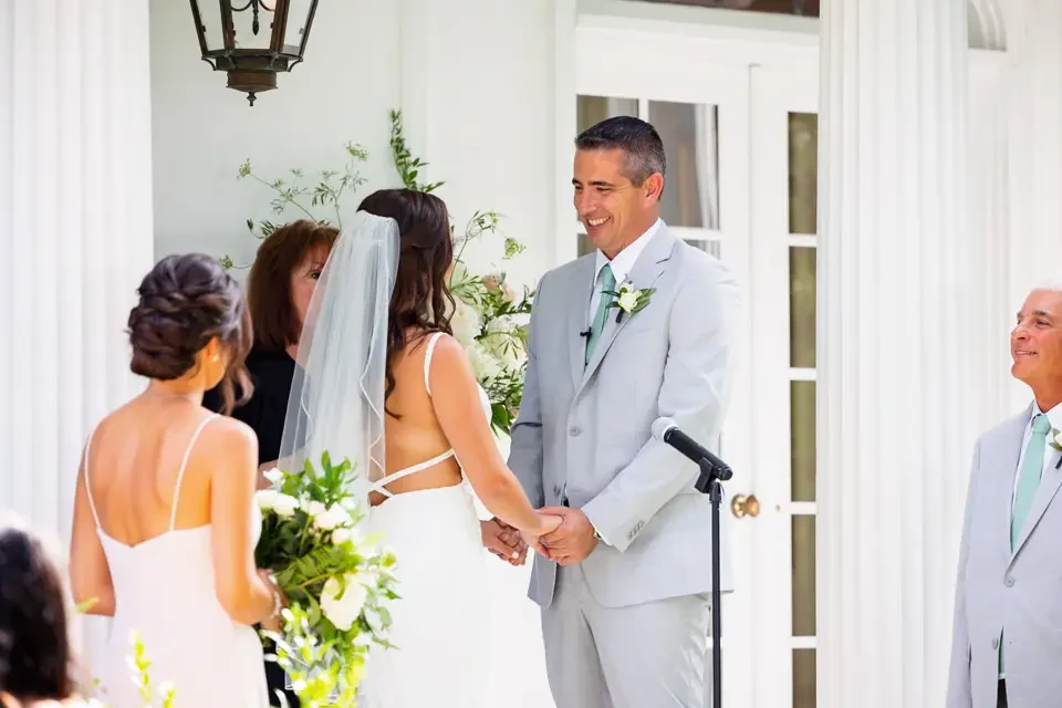 bride-and-groom-holding-hands-outdoor-ceremony.webp