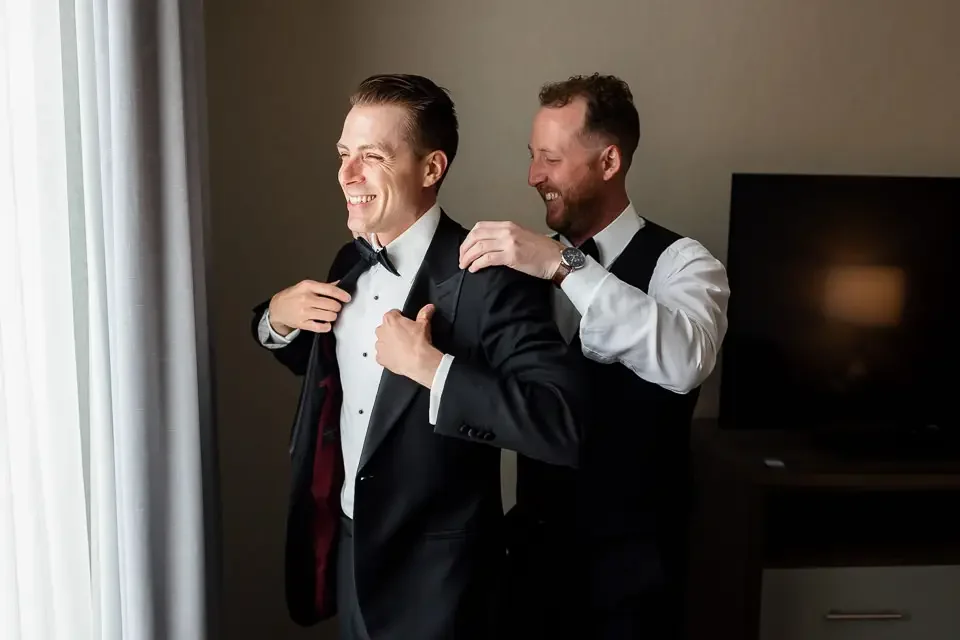groom-getting-ready-with-friend.webp