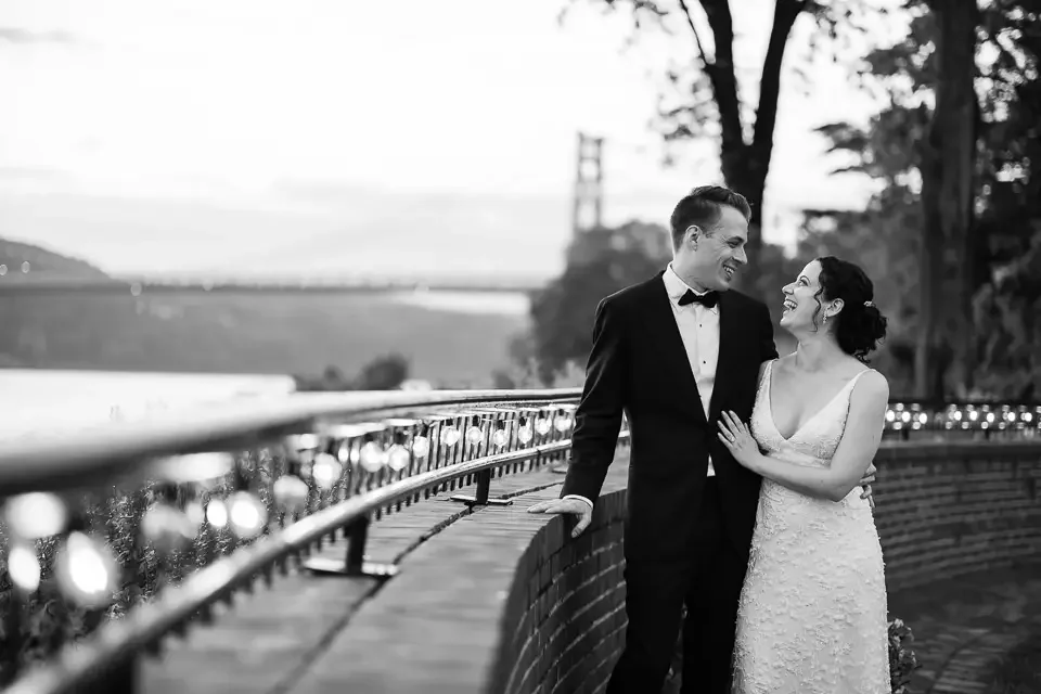 Black and white wedding portraits by the water at sunset
