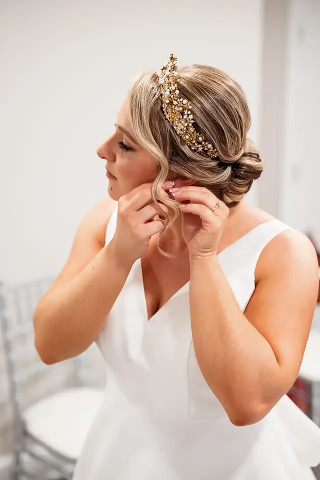 Bride Putting on Earrings Before the Ceremony
