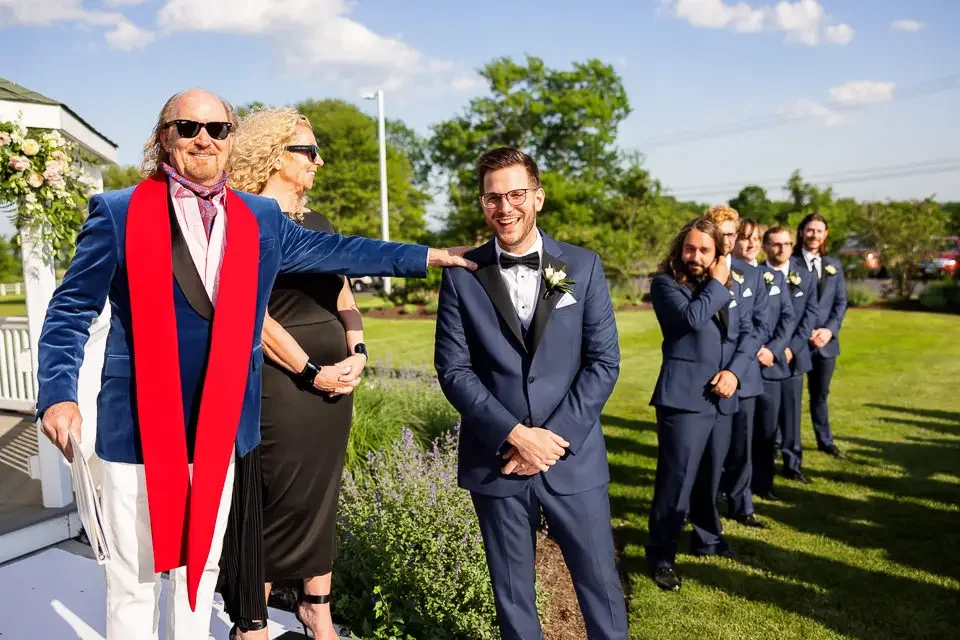 Outdoor Wedding Ceremony Begins with Groom and Wedding Party