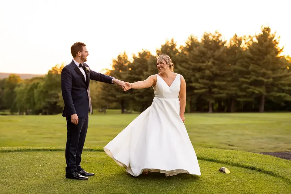 Playful sunset wedding portrait on the lawn