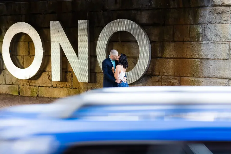 Romantic Engagement Portrait with Bold City Backdrop