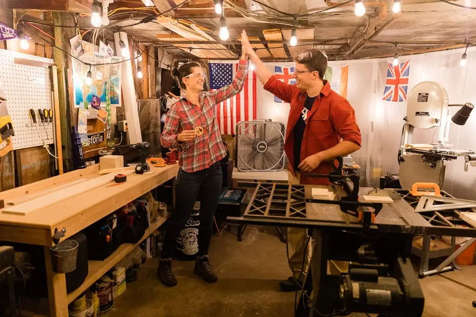 Engaged Couple Celebrating Together in Their Workshop