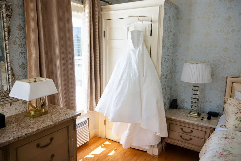 Wedding Dress Hanging in Natural Light Before Ceremony