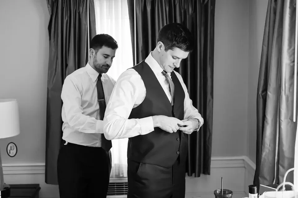 Groom Preparing with Support from a Friend