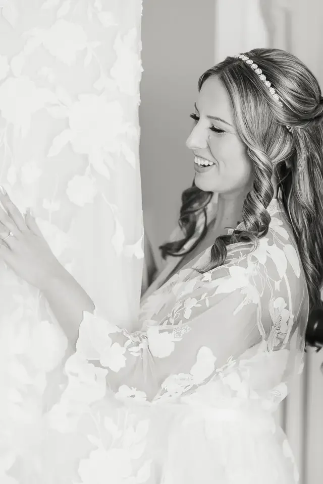 Bride Admiring Wedding Dress During Getting Ready