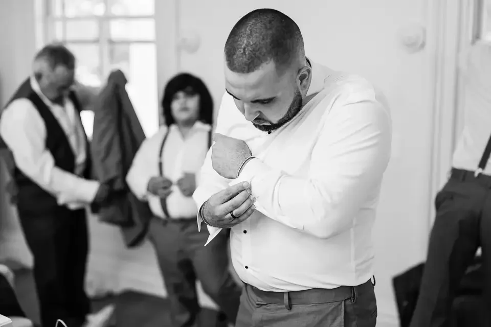 Candid Groom Getting Ready Moment with Coastal Wedding Influence