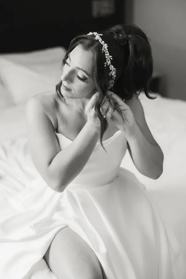 Bride Putting on Earrings Before Ceremony