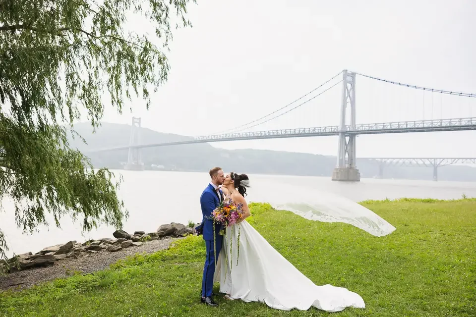 Waterfront Wedding Kiss with Flowing Veil
