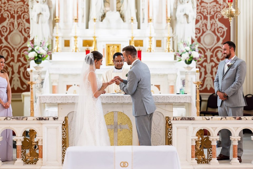 bride-groom-exchanging-rings-altar-facing.jpg