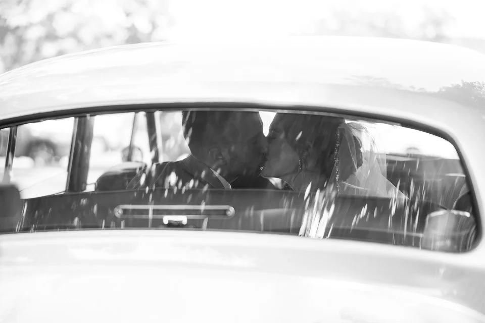 couple-kissing-inside-classic-white-car.jpg