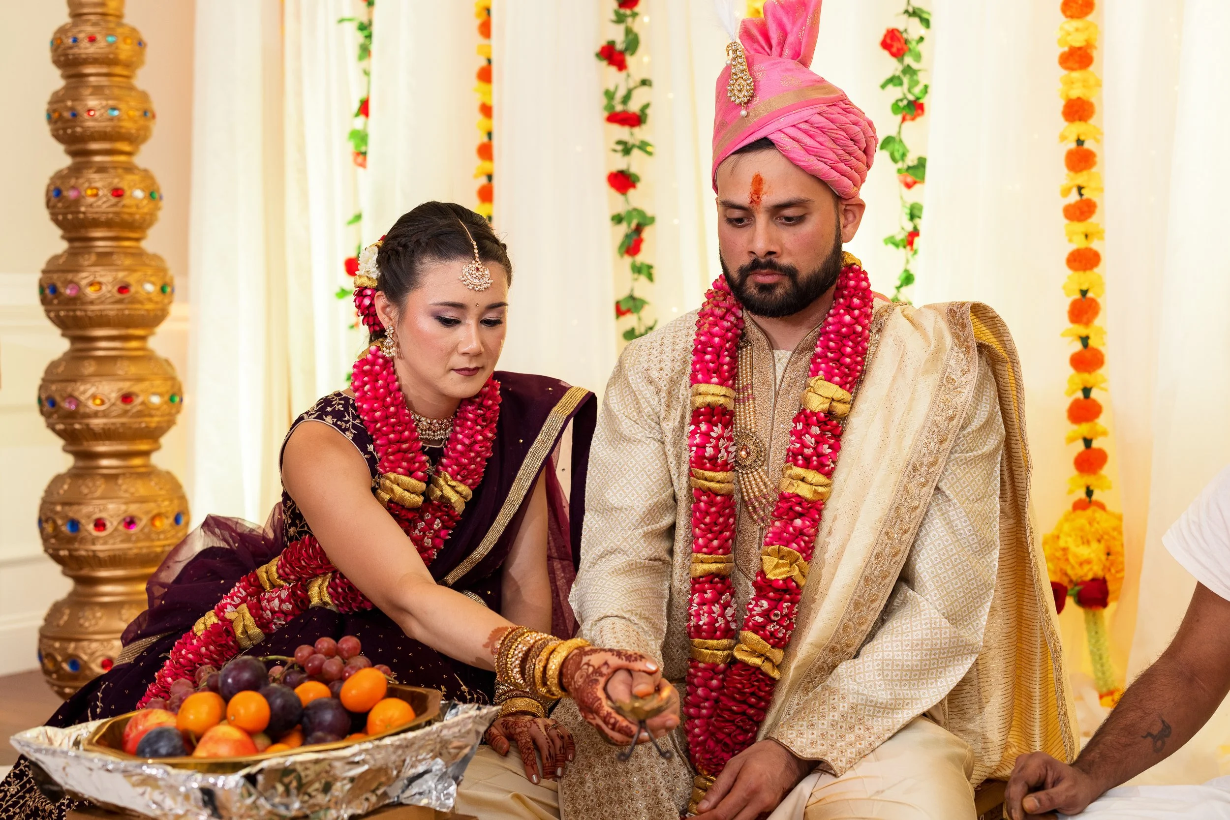couple-traditional-attire-seated-together-ceremony.jpg