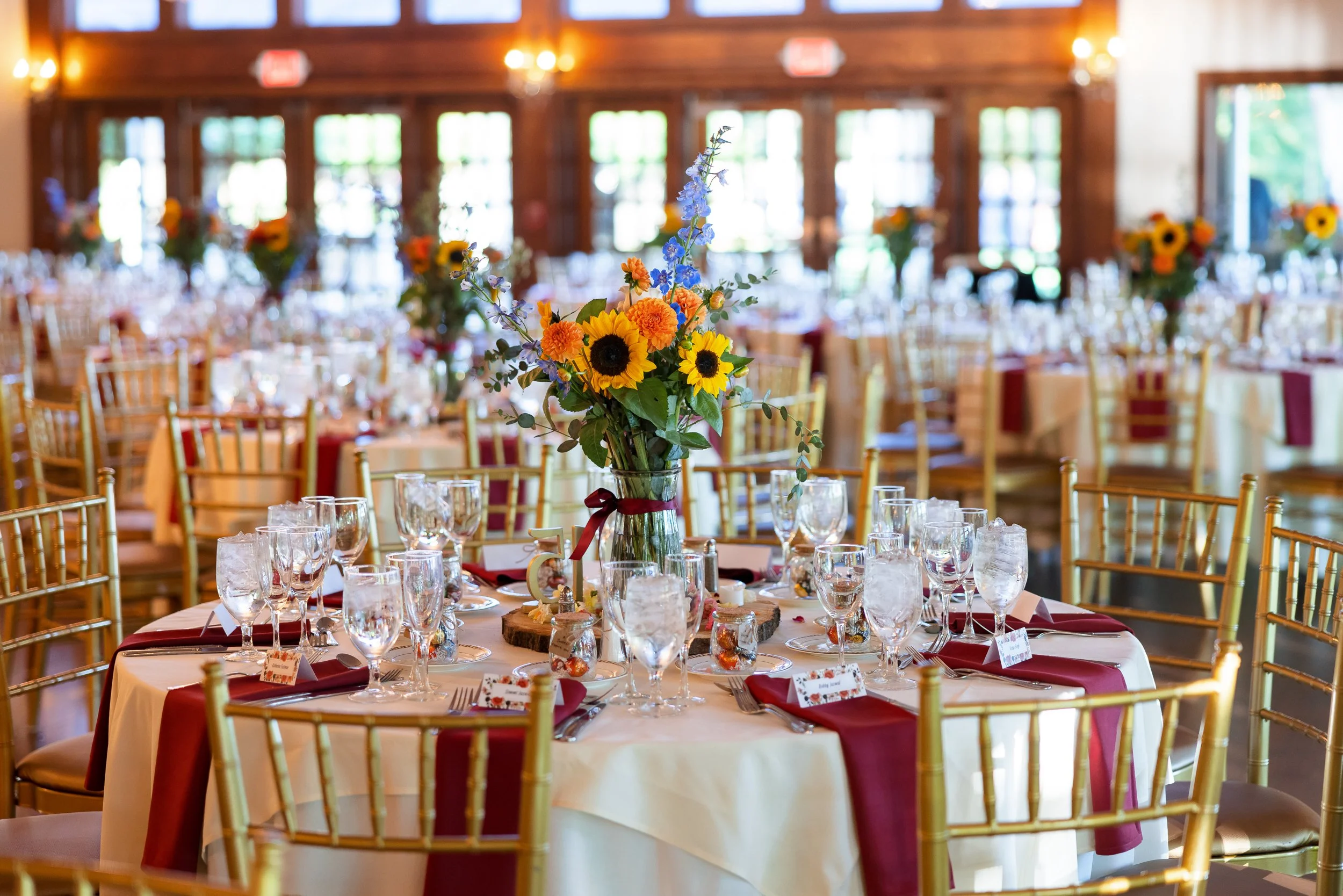 reception-table-sunflower-centerpiece-burgundy-linens.jpg