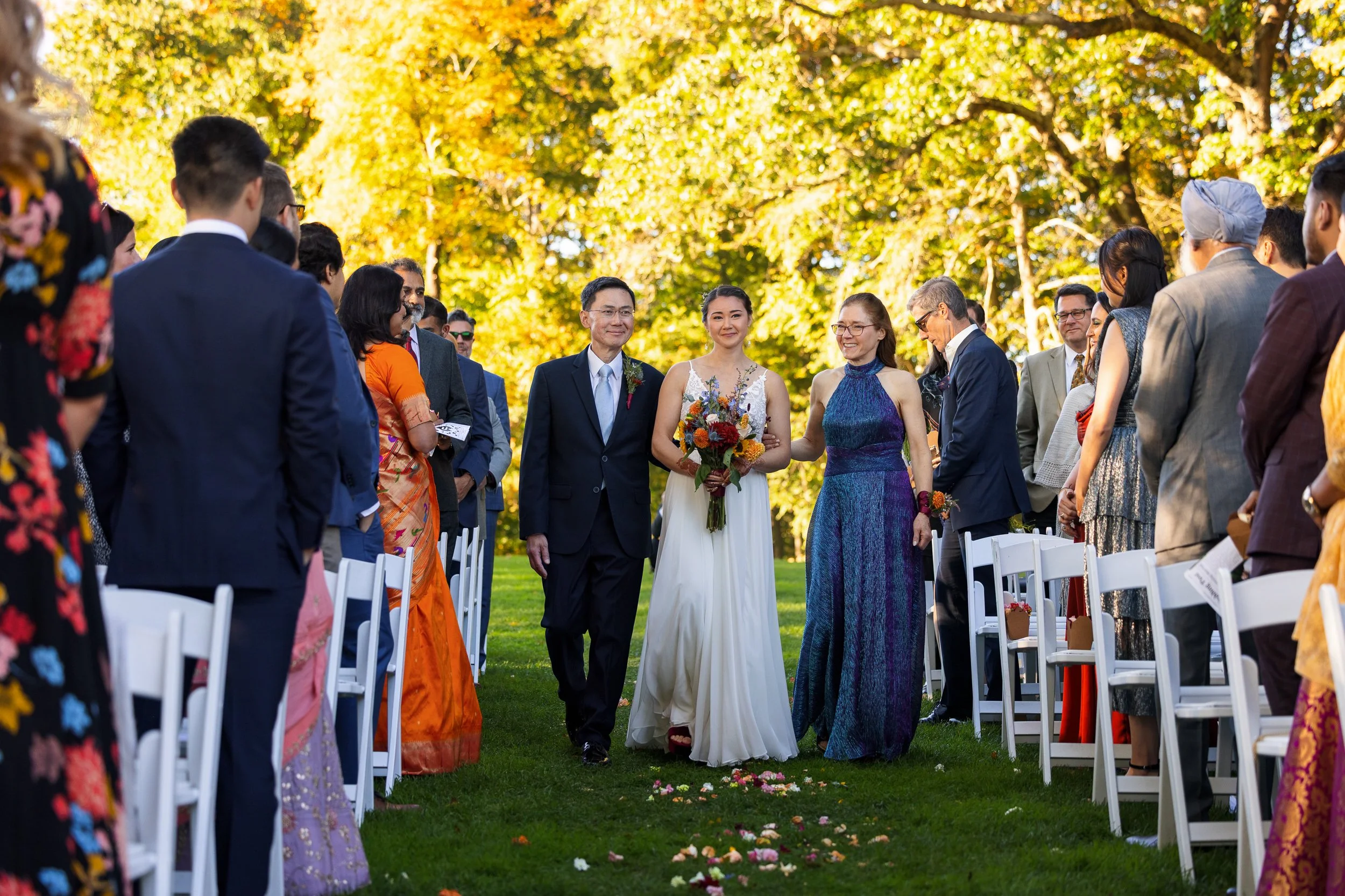 bride-parents-walking-together-aisle-lined.jpg