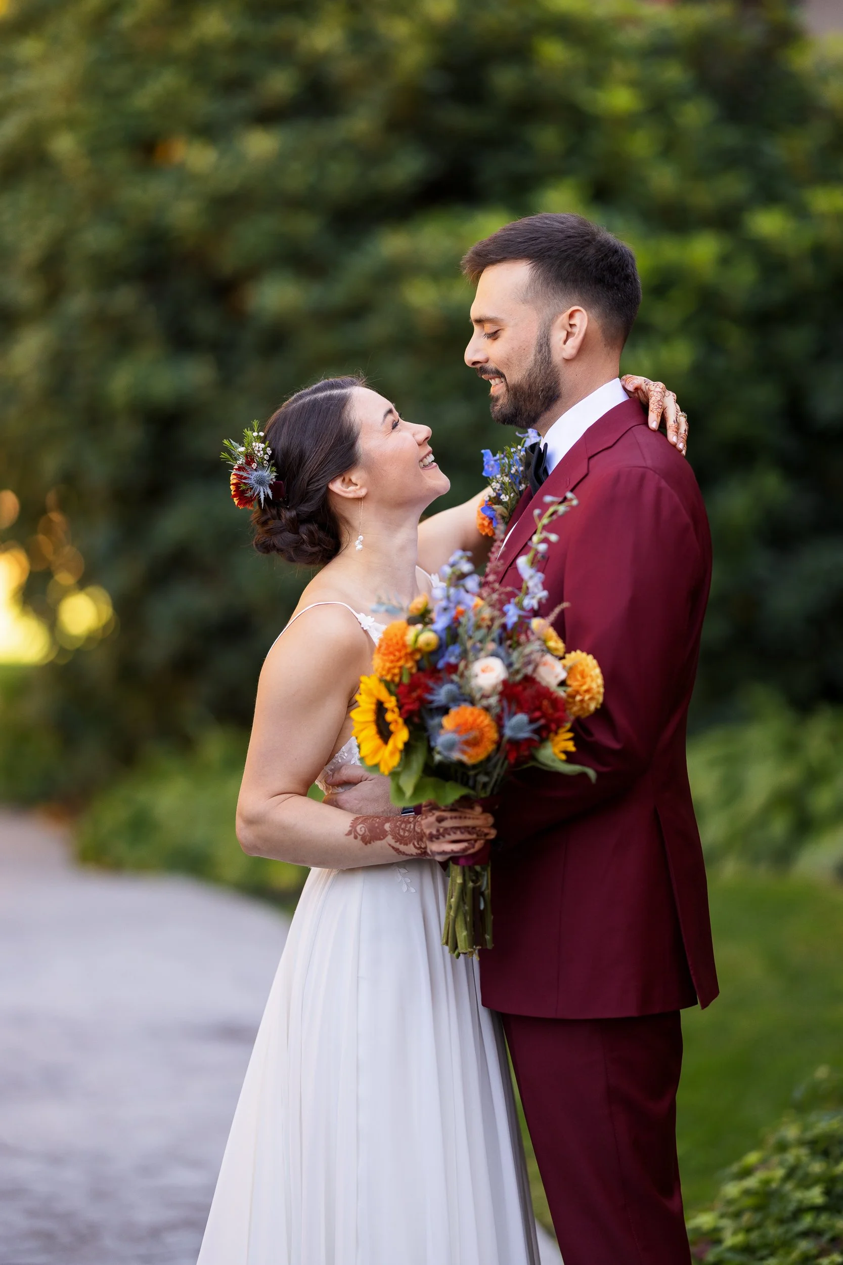 bride-groom-facing-each-smiling-holding.jpg