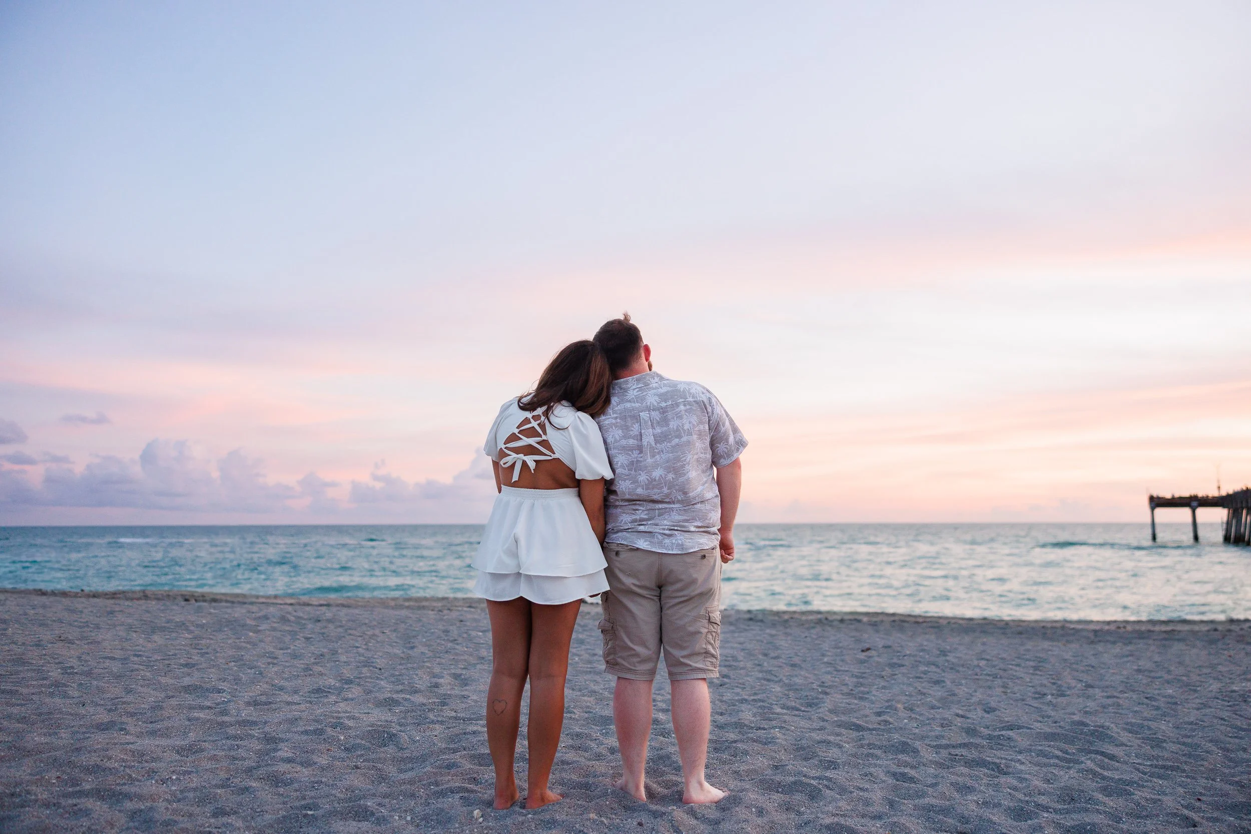 12-couple-standing-together-beach-facing-ocean.jpg