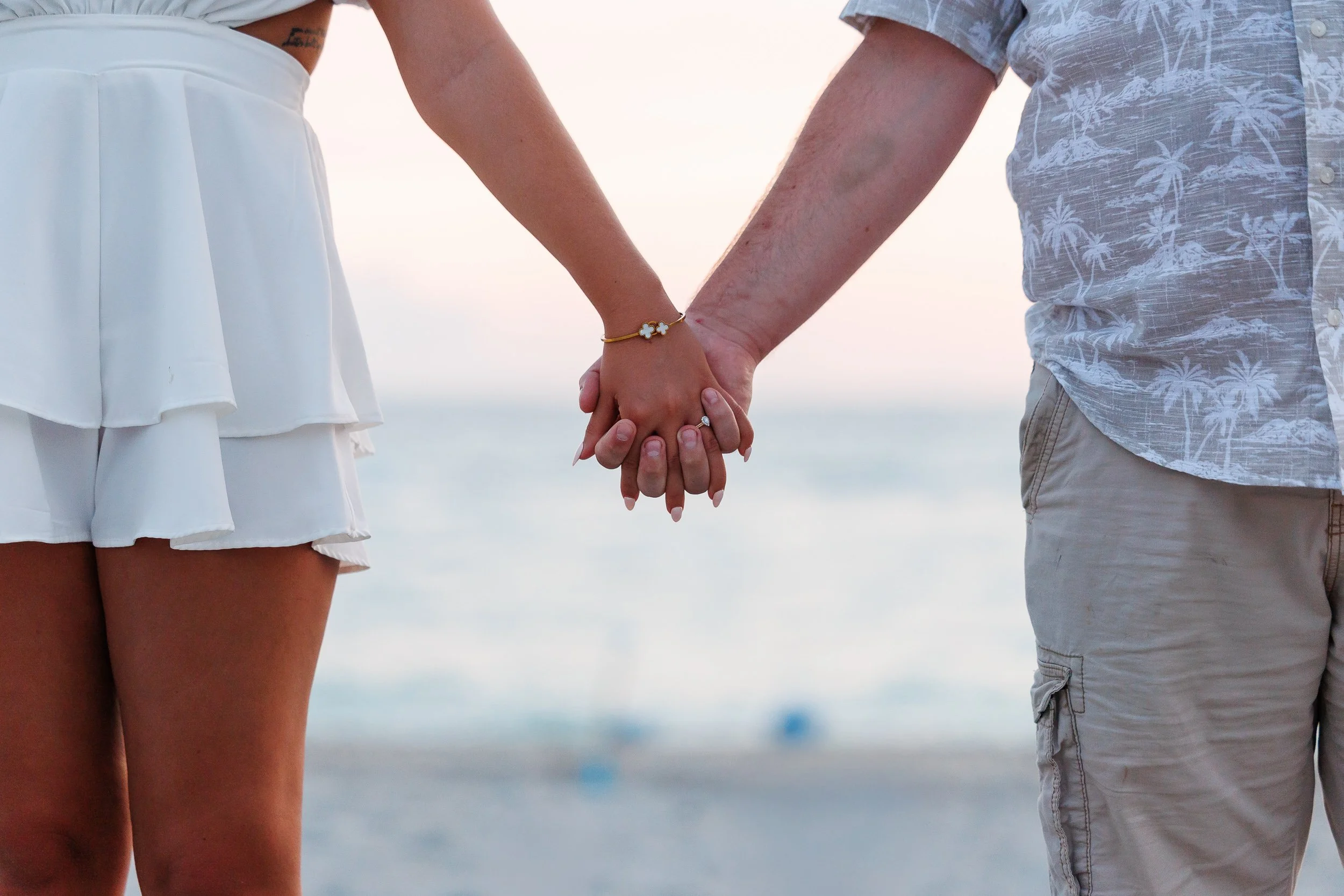 10-couple-holding-hands-beach-overlooking-water.jpg
