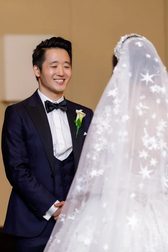 21-groom-navy-tuxedo-smiling-facing-bride.jpg
