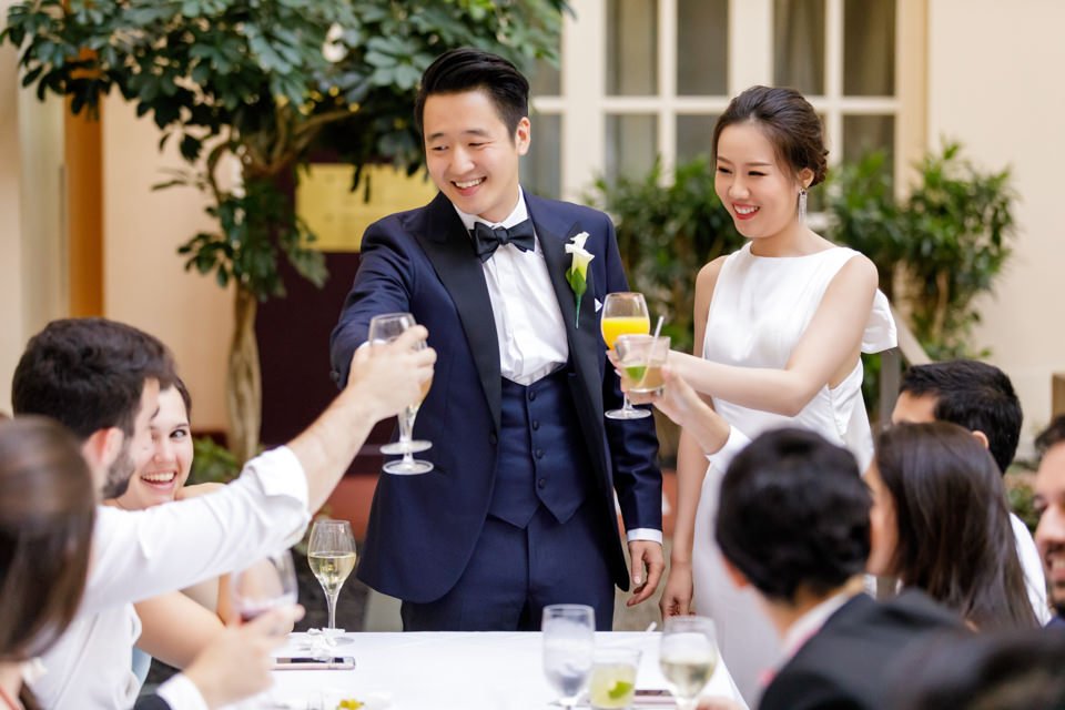 24-couple-formal-wear-smiling-guests-raise.jpg
