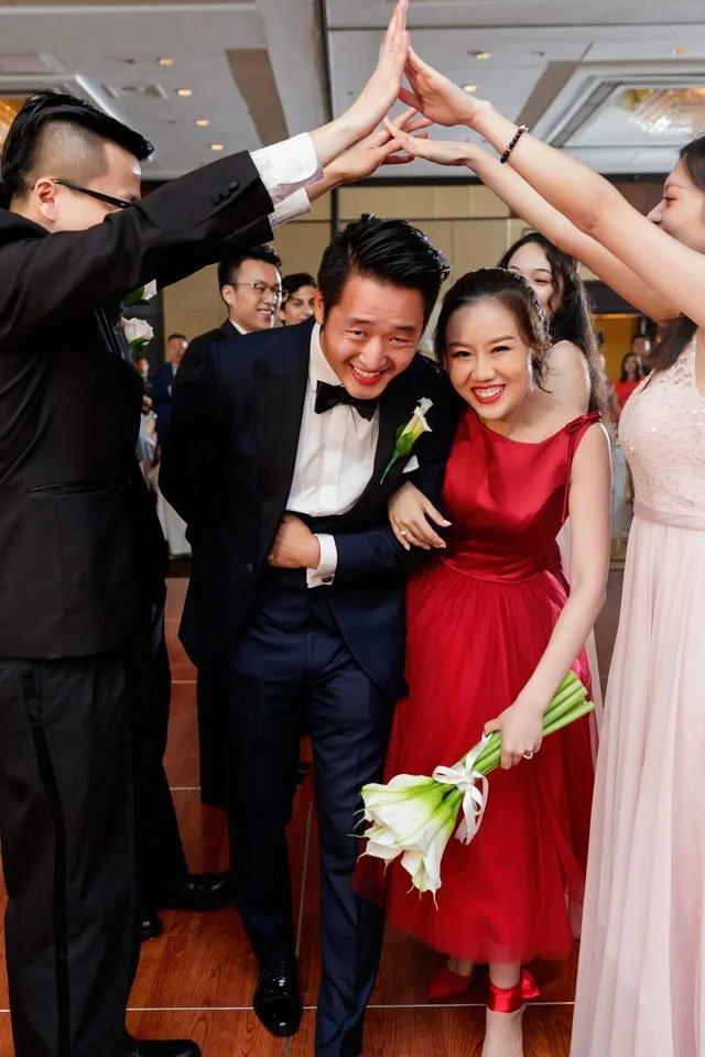 26-bride-groom-smiling-guests-form-arch.jpg