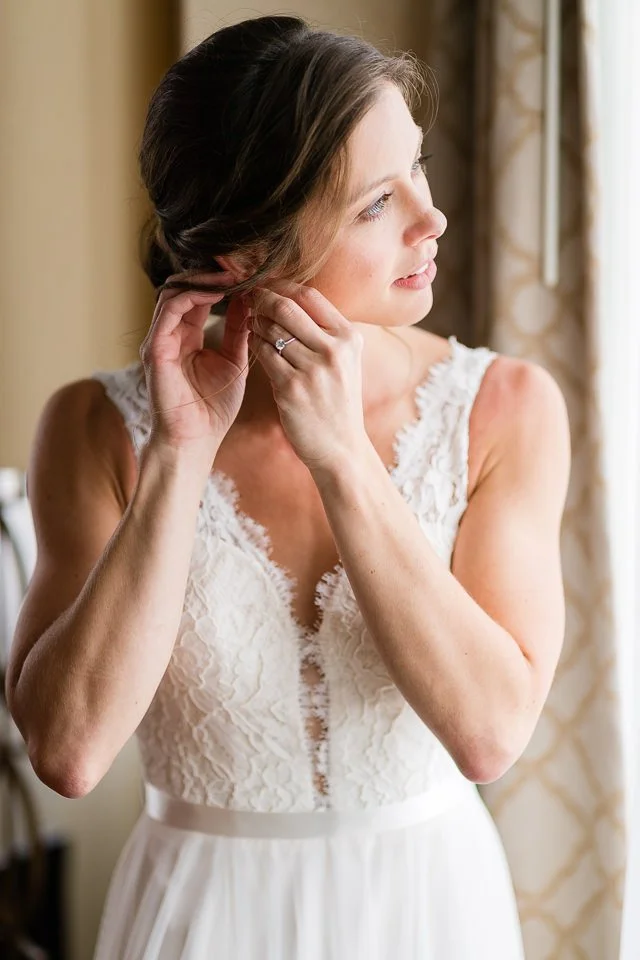 07-bride-white-lace-dress-adjusts-earring.jpg