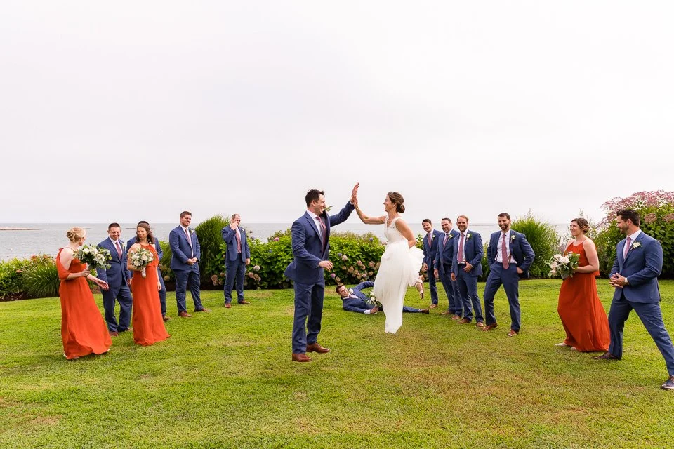 16-bride-groom-high-fiving-lawn-overlooking.jpg