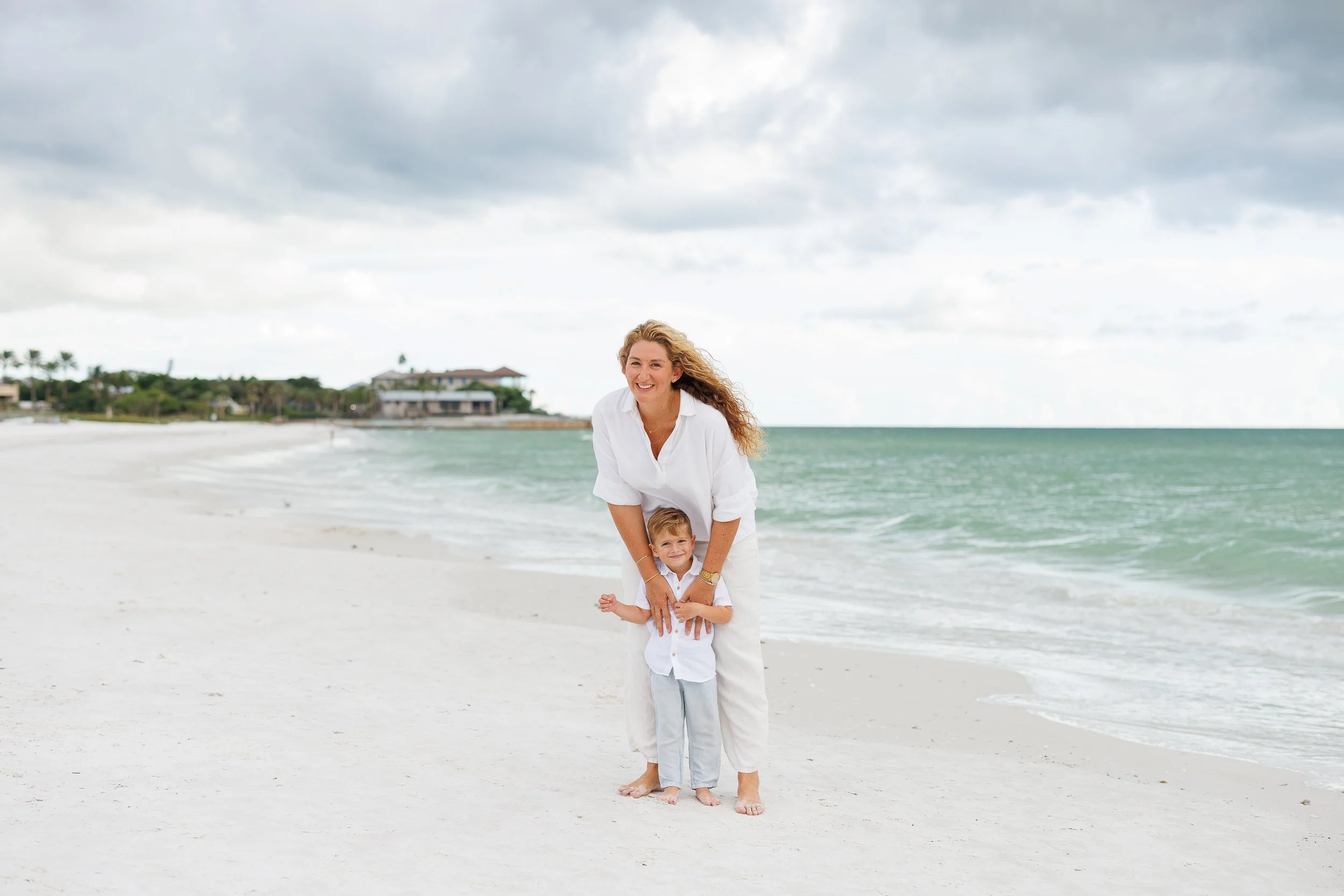 A parent and child on the sand at Crescent Beach in Sarasota