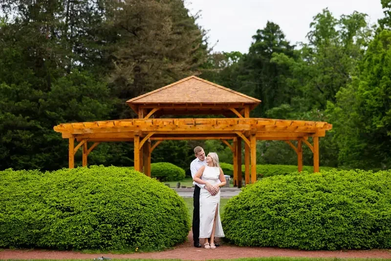 Engaged couple standing comfortably together during an engagement session, gently guided into a natural pose that feels relaxed and authentic.