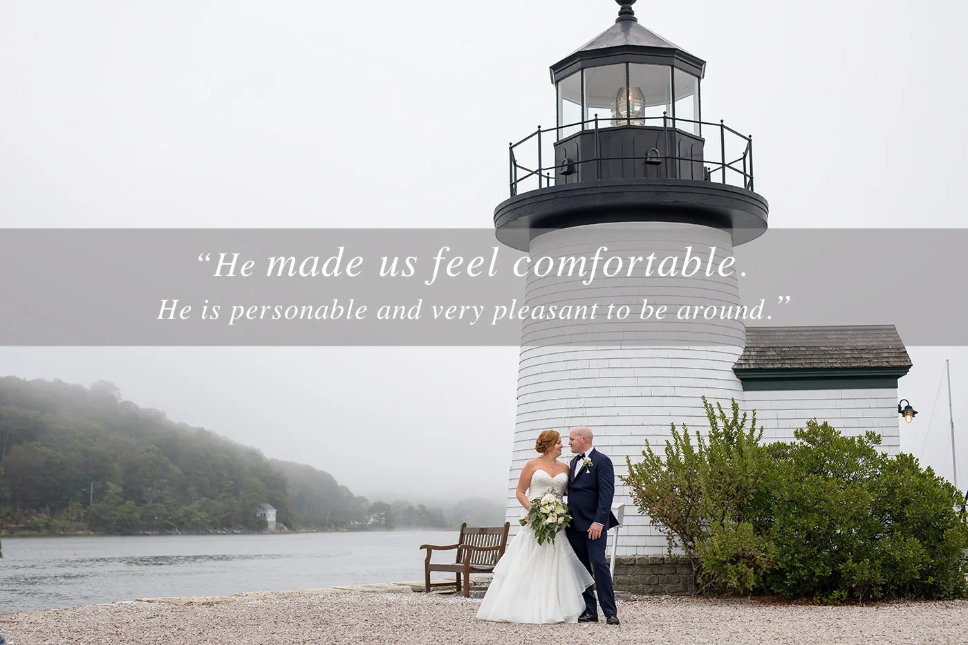 Bride and groom stand together near a lighthouse during a romantic waterfront wedding portrait on a foggy day.