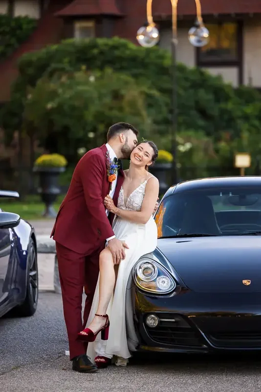 Bride and groom sharing a joyful, candid moment together during an evening wedding portrait.