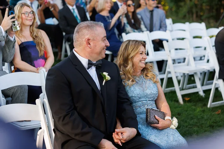 Close family members seated during the ceremony, visibly emotional and fully present for the couple’s vows.