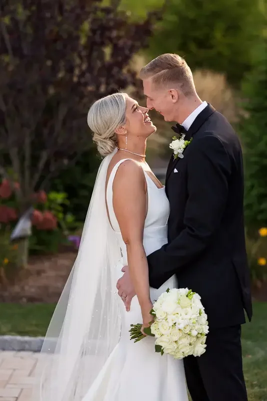 Romantic wedding portrait of a bride and groom sharing a quiet moment together outdoors.