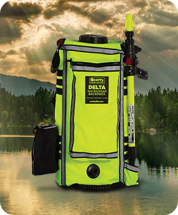 High-visibility green and black waterproof backpack with a water gun extension, set against a lakeside background with trees and cloudy sky.